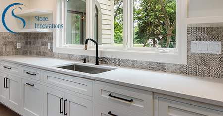 white counters and cabinets with grey printed backsplash